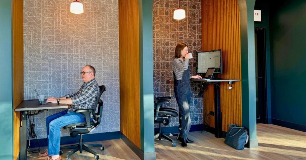 two members of brick and mortar using our booths and sit/stand desks