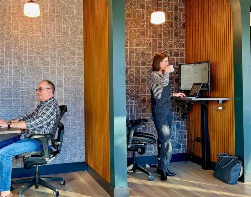 two members of brick and mortar using our booths and sit/stand desks