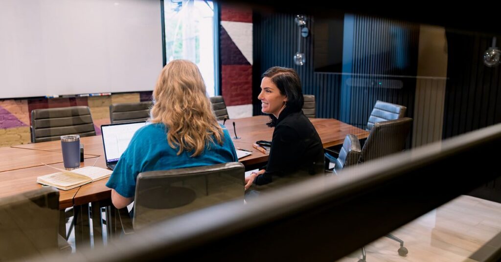 two executives using a large Brick and Mortar meeting room for Q4 planning