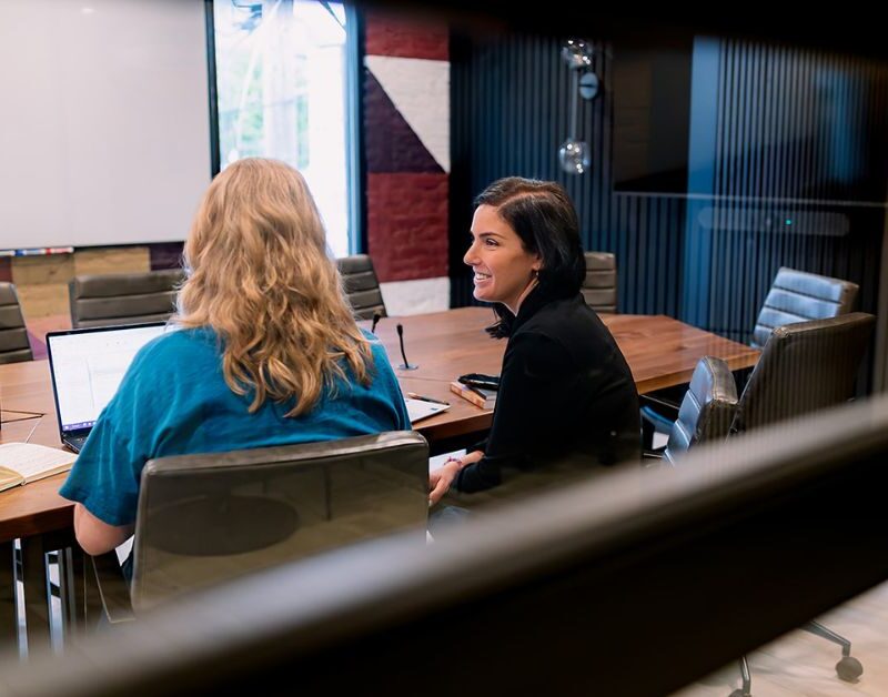 two executives using a large Brick and Mortar meeting room for Q4 planning