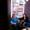 Two women having a professional meeting inside a Brick & Mortar workspace.