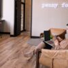 woman sitting in a brick and mortar working on her laptop and using the The 2-Minute Reset guide That Instantly Improves Focus